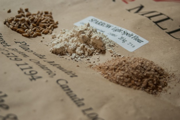 Three stages of grain flour processing in piles on a K2 Milling brand SPARROW light spelt 20kg bag